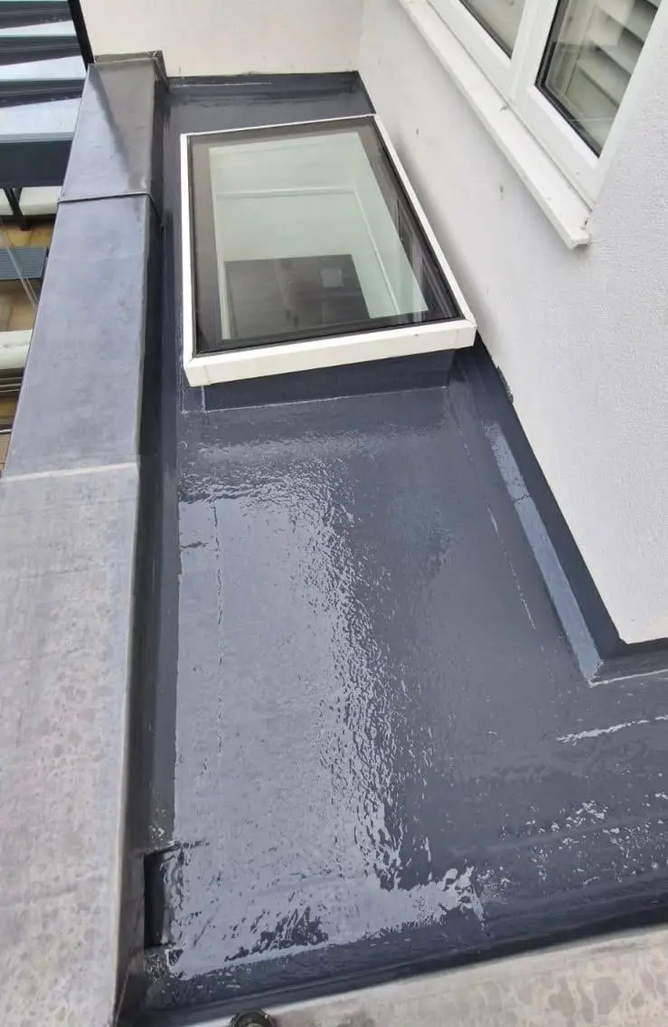 Liquid waterproofed flat roof finished up to a rooflight and parapet upstand