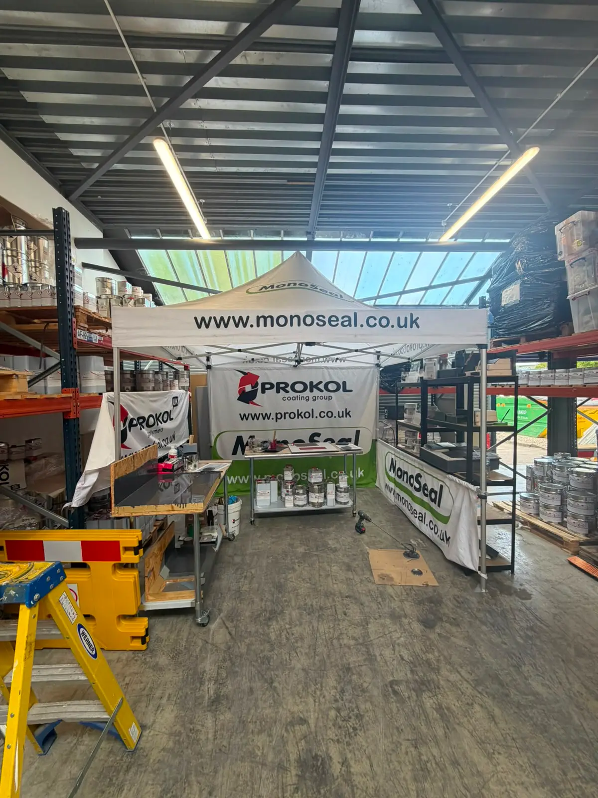 Liquid waterproofing materials and coatings laid out at a trade supplier stand